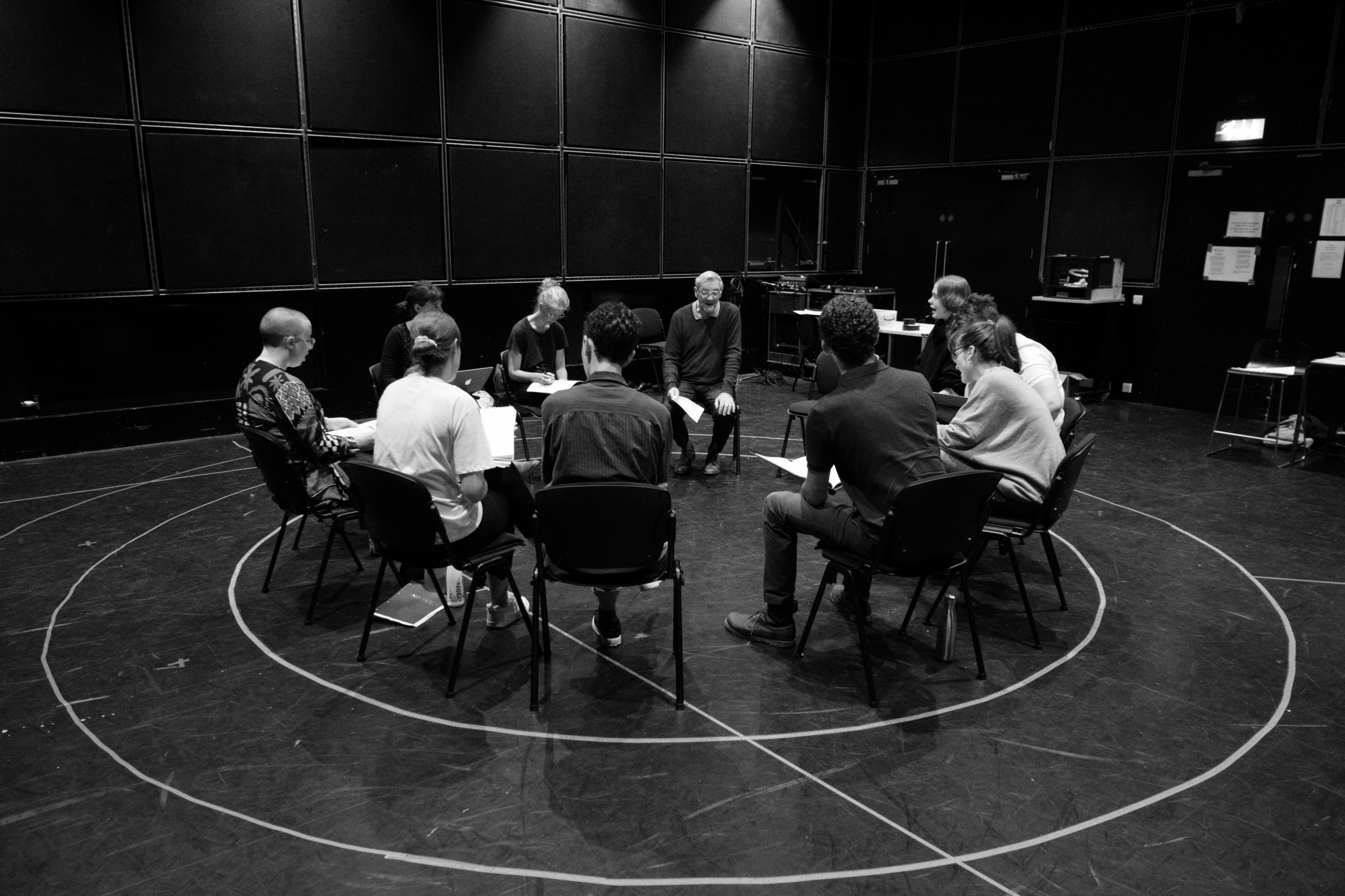 Cast sit in a circle reading the play