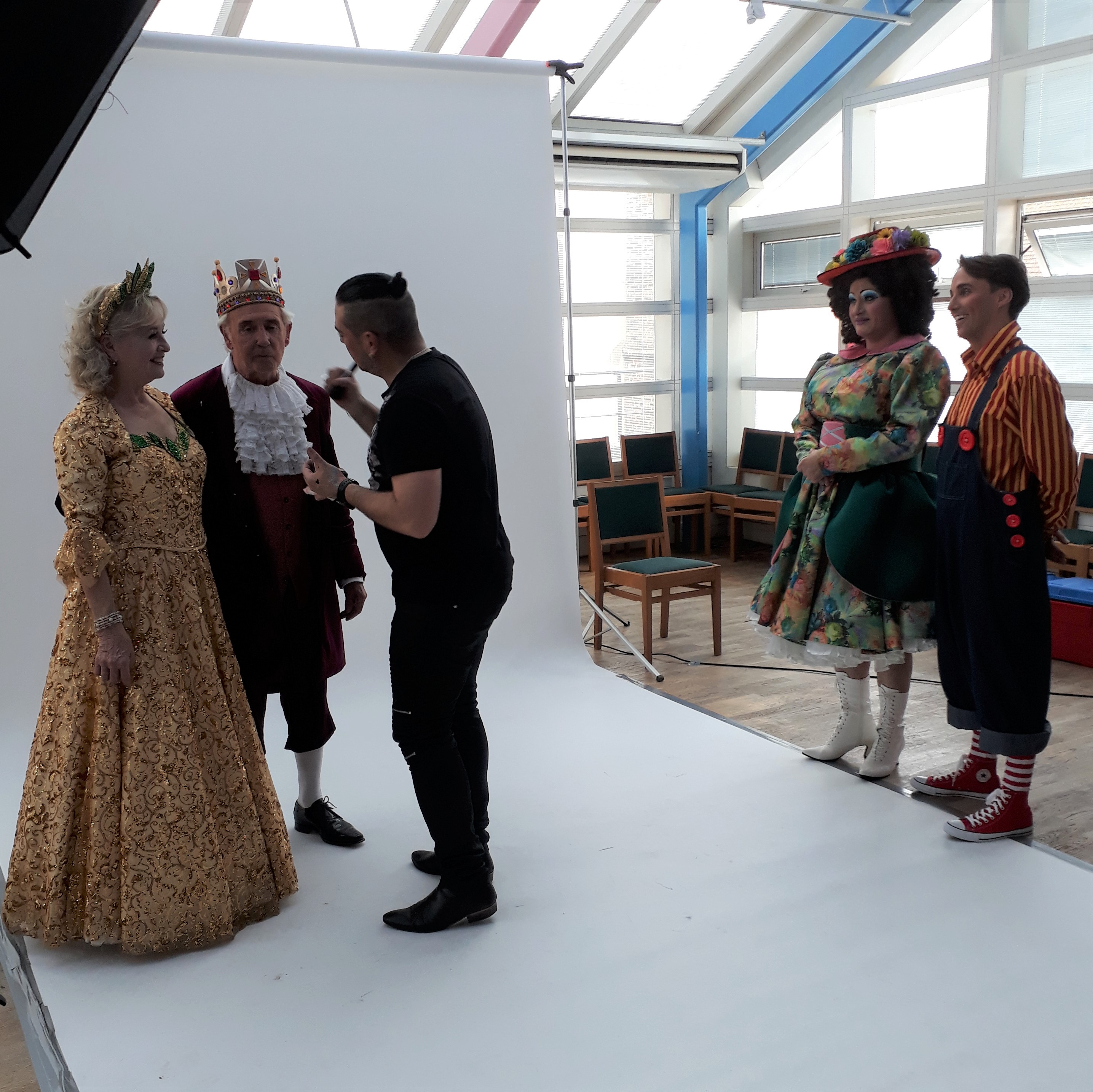 The King and Good Fairy having their make-up done at a photo-shoot