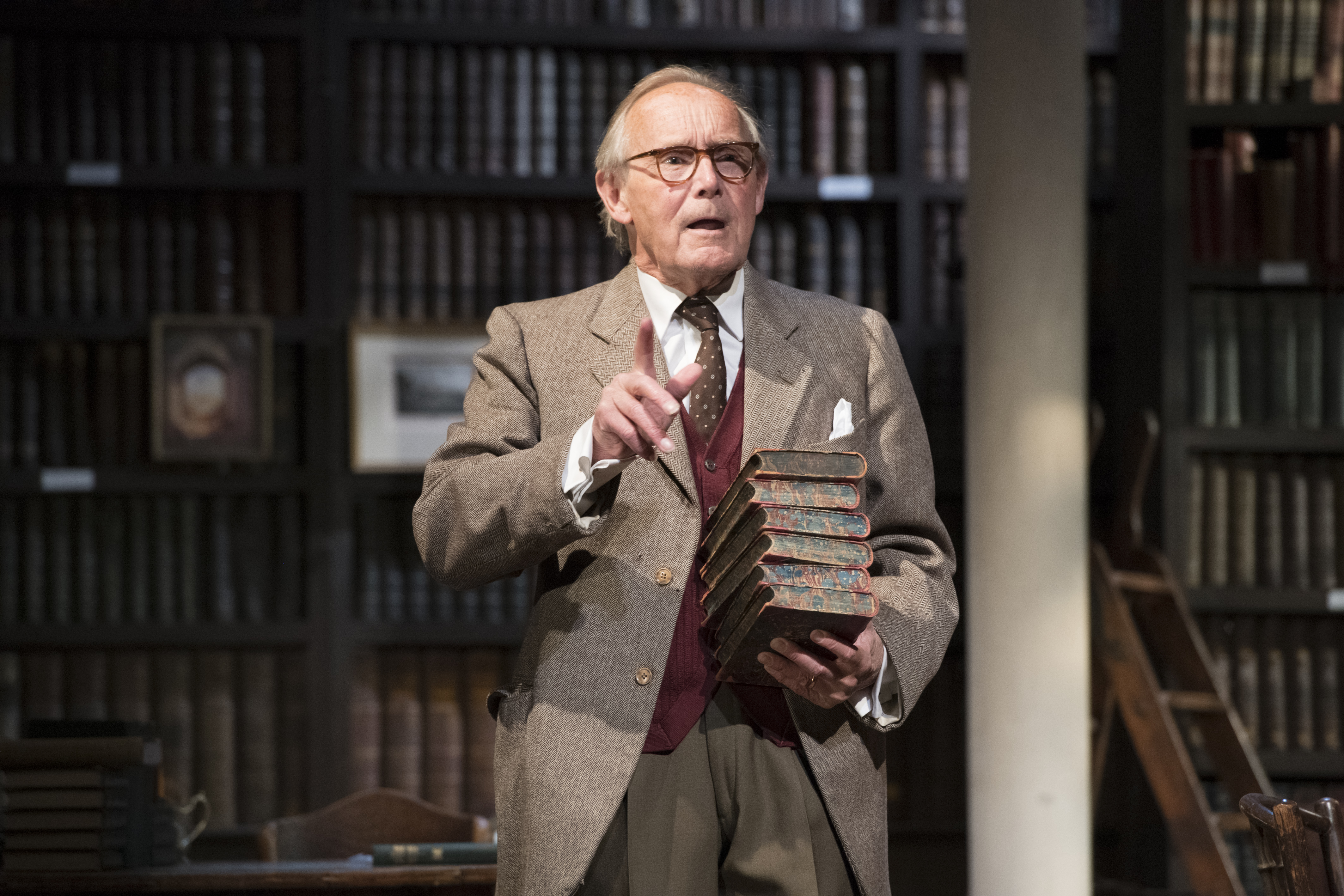 Man stood with stack of books