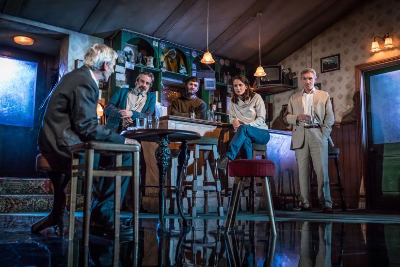 A group of people talking in a pub