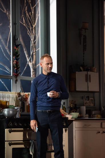 A man stands in a kitchen