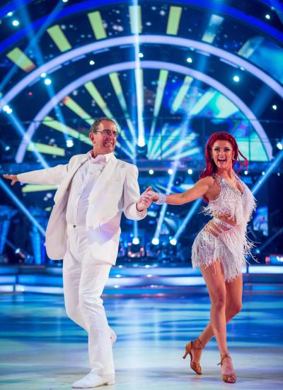 Strictly Come Dancing dance shot of Rev Richard Coles in a white suit and his partner