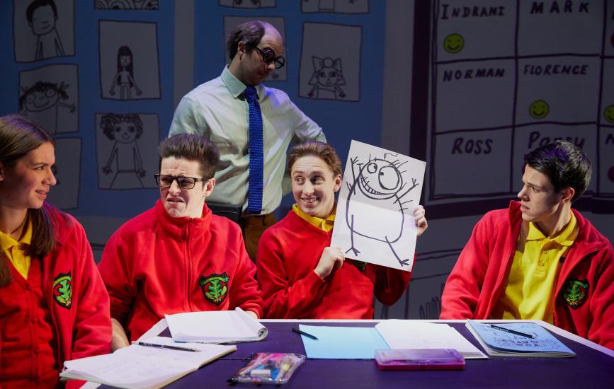 A group of children sit round a table drawing