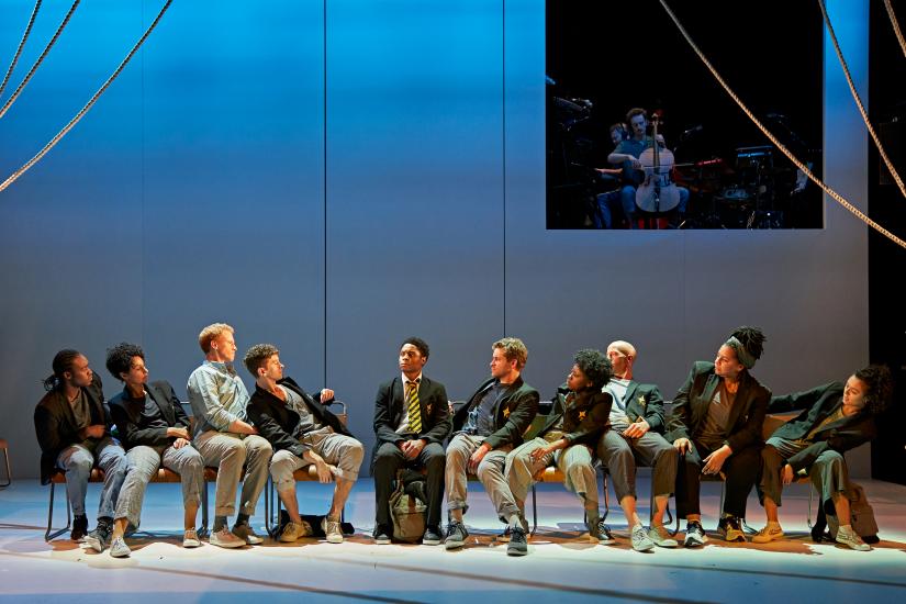 Cast of A monster Calls sitting on a line of chairs