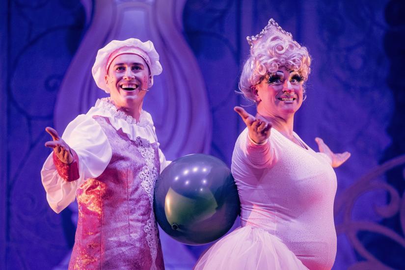 Wishy Washy and Dame Trott wearing ballet costumes, balancing a balloon between their bodies