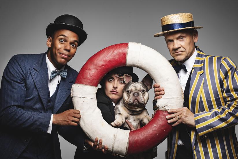 Fred Karno, Charlie, Stan and a French Bulldog pose with a lifebuoy