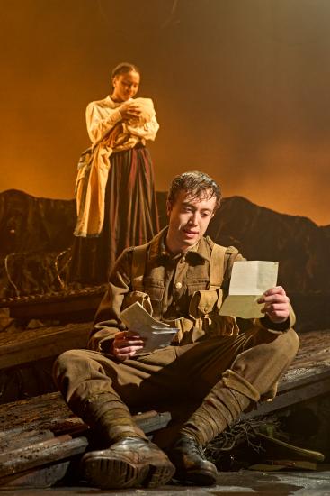 Tommo reading a letter in the trenches
