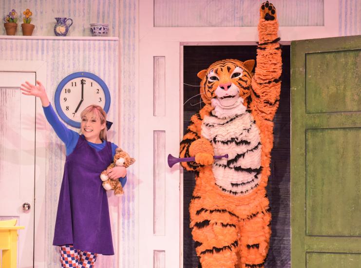 Sophie and the Tiger are waving and smiling