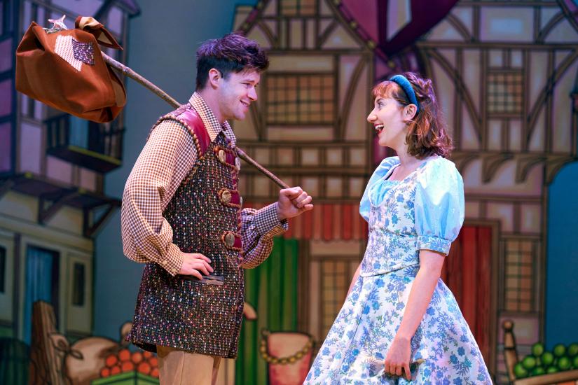 Dick Whittington and Alice Fitzwarren stare into each other's eyes lovingly, Dick is holding a knapsack