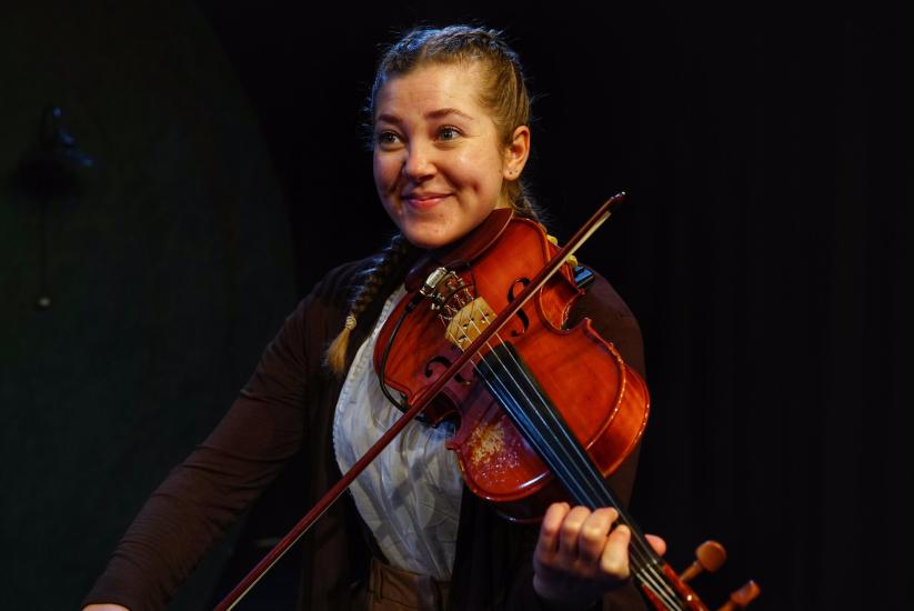 A woman plays a violin