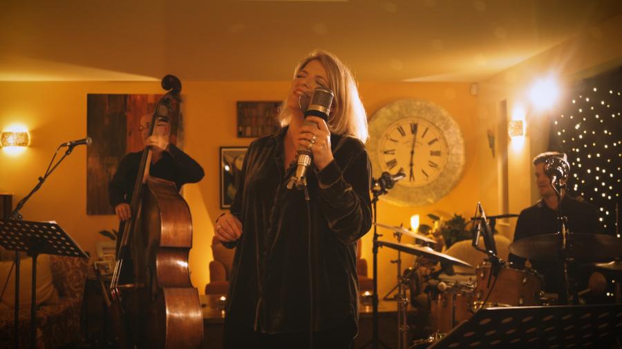 Woman sings in well lit room