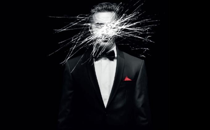 An image of a man in a tuxedo, his face has been scratched out