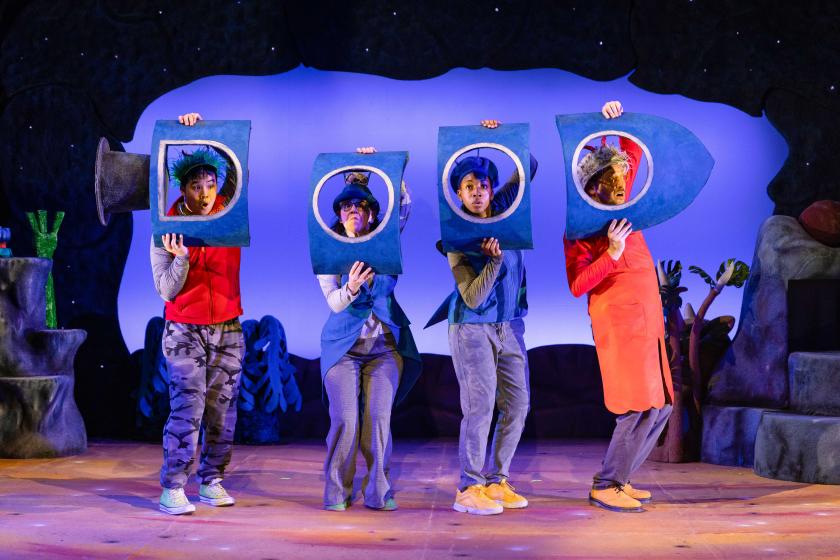 4 people are pretending to be in a purple spaceship, they have a window for each of their heads
