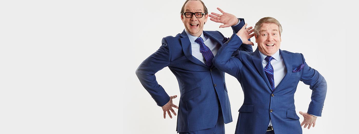 Two men in blue suits mimic Morecambe and Wise's classic Bring me Sunshine dance