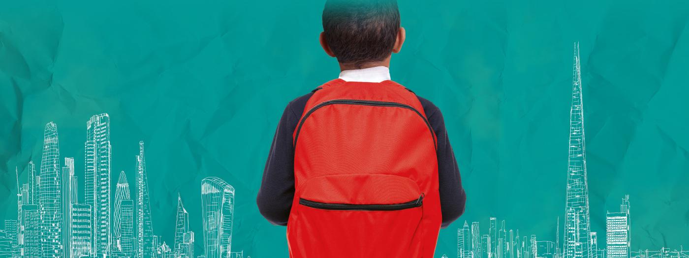 A boy is wearing a red backpack, he has dark skin and hair, he faces away from the image so you can't see his face.