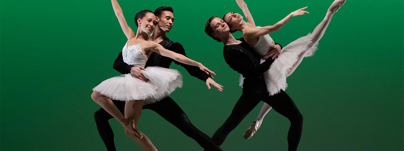 Two pairings of male and female dancers in traditional tutus and black costumes