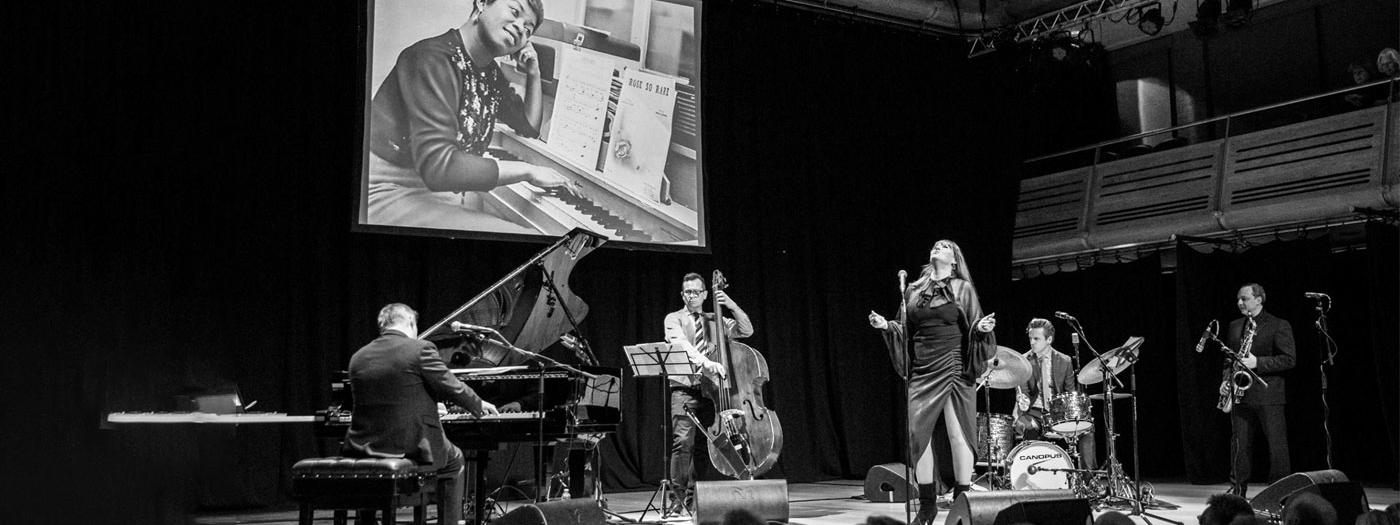 A black and white photograph of a jazz band on stage