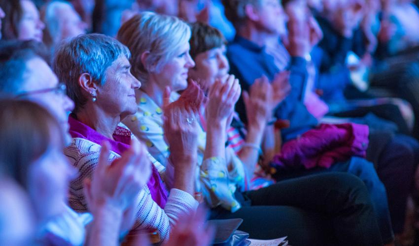 Audience member clapping